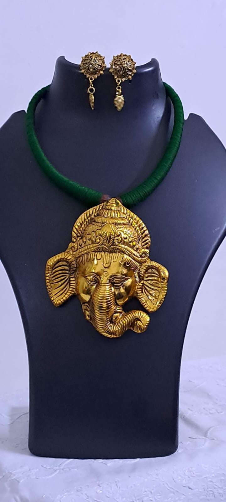 Green thread necklace with golden oxidised ganesha pendant