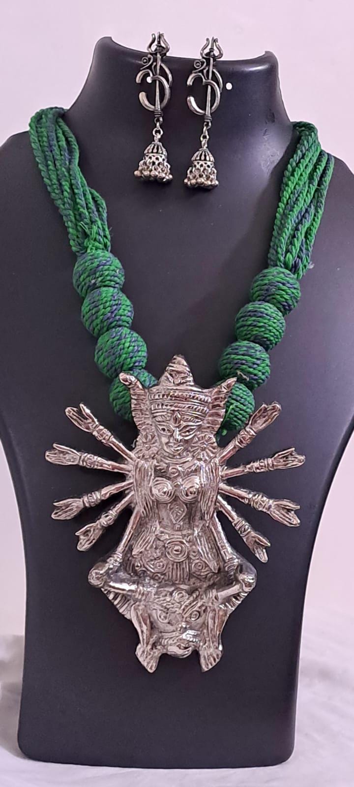 Green thread necklace with oxidised golden durga pendant