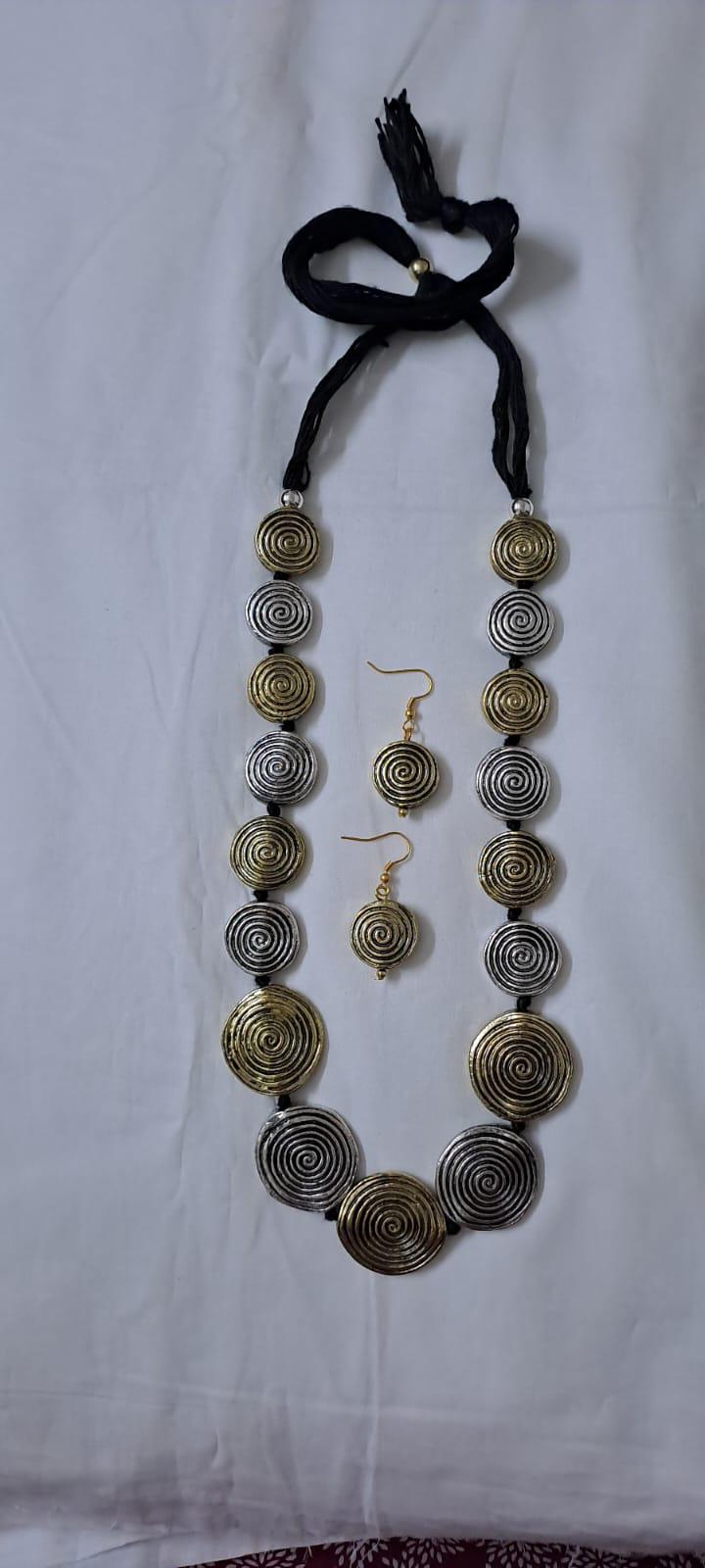 Exclusive silver oxidised set with flat round beads of gold n silver tone mix n matching earrings