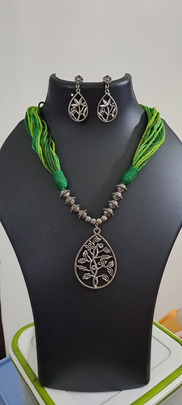 Green thread necklace with silver oxidised traditional pendant