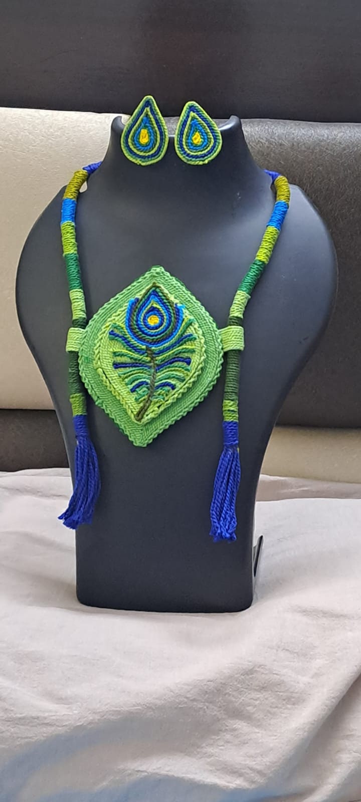 Thread necklace depicting peacock feather with shades of green. Exclusively for Janmashtami