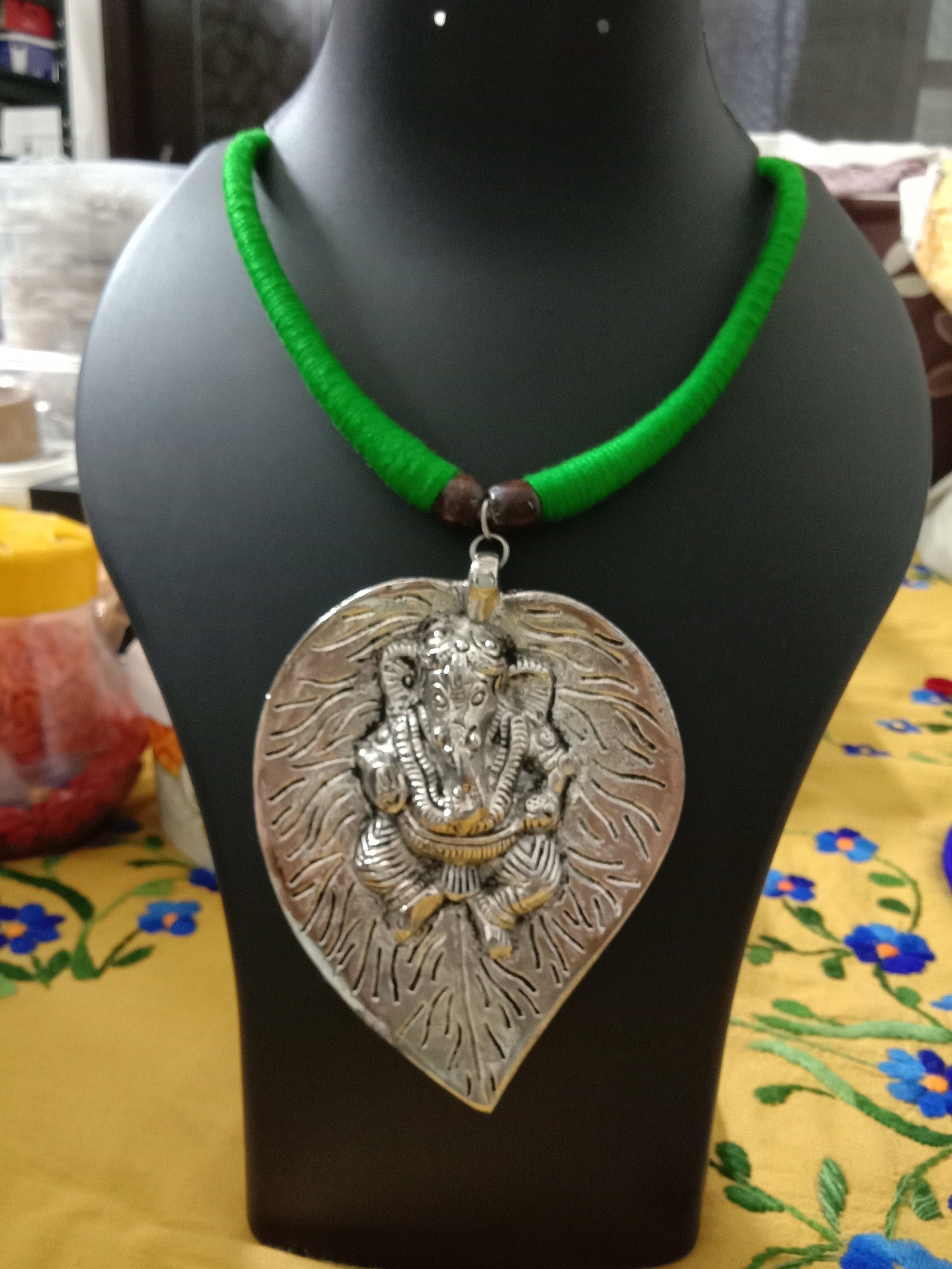 Green thread necklace with silver oxidised ganesha pendant