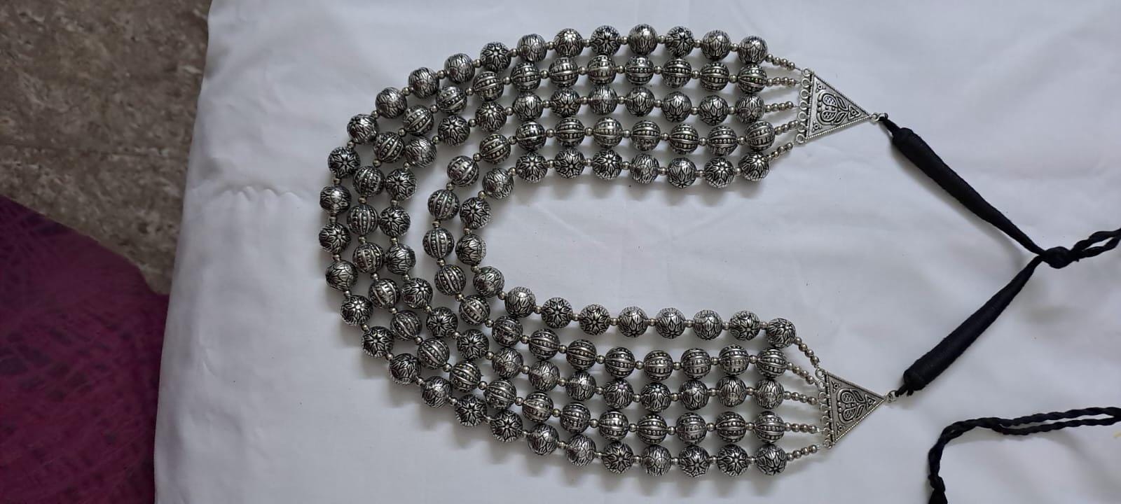 Multi-layered silver oxidised beads necklace .