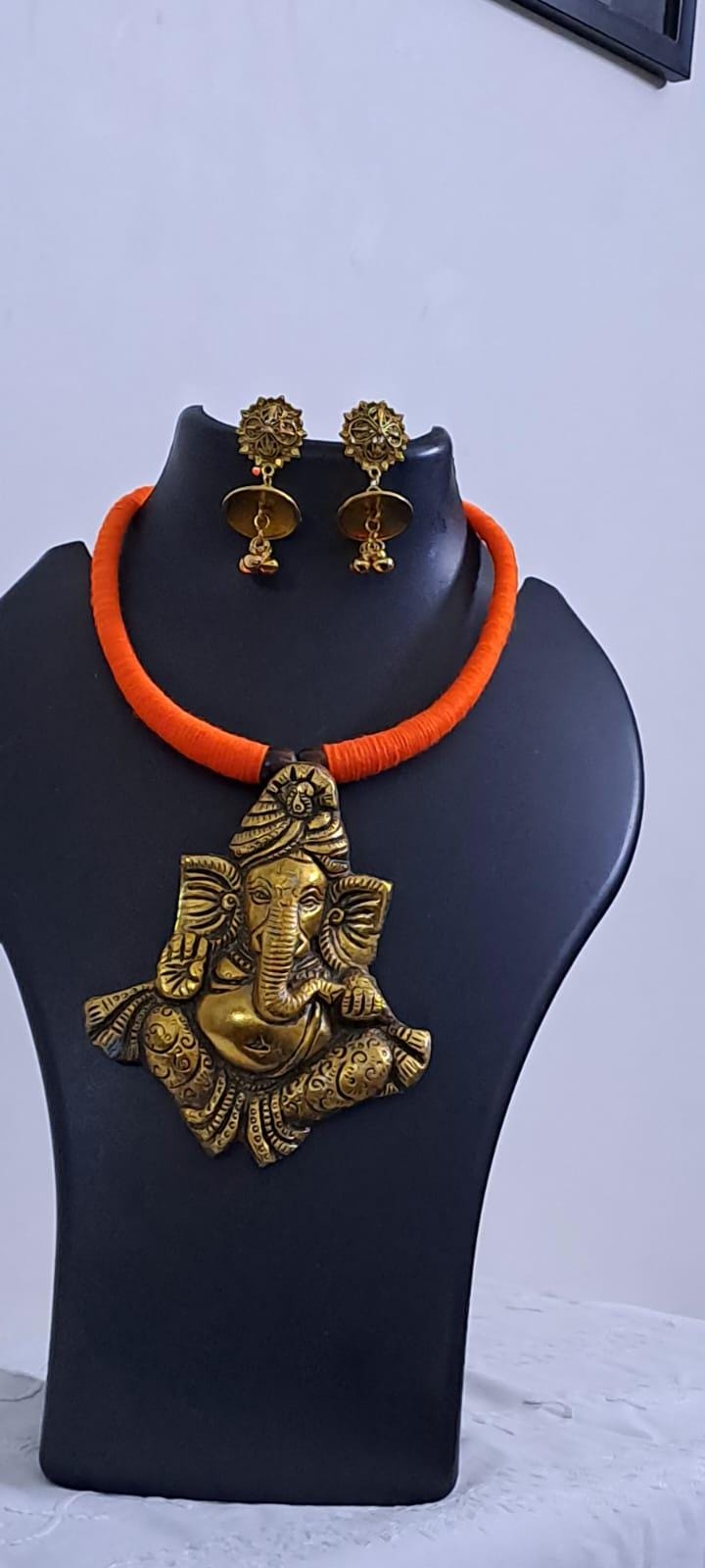 Orange thread necklace with golden oxidised ganesha pendant