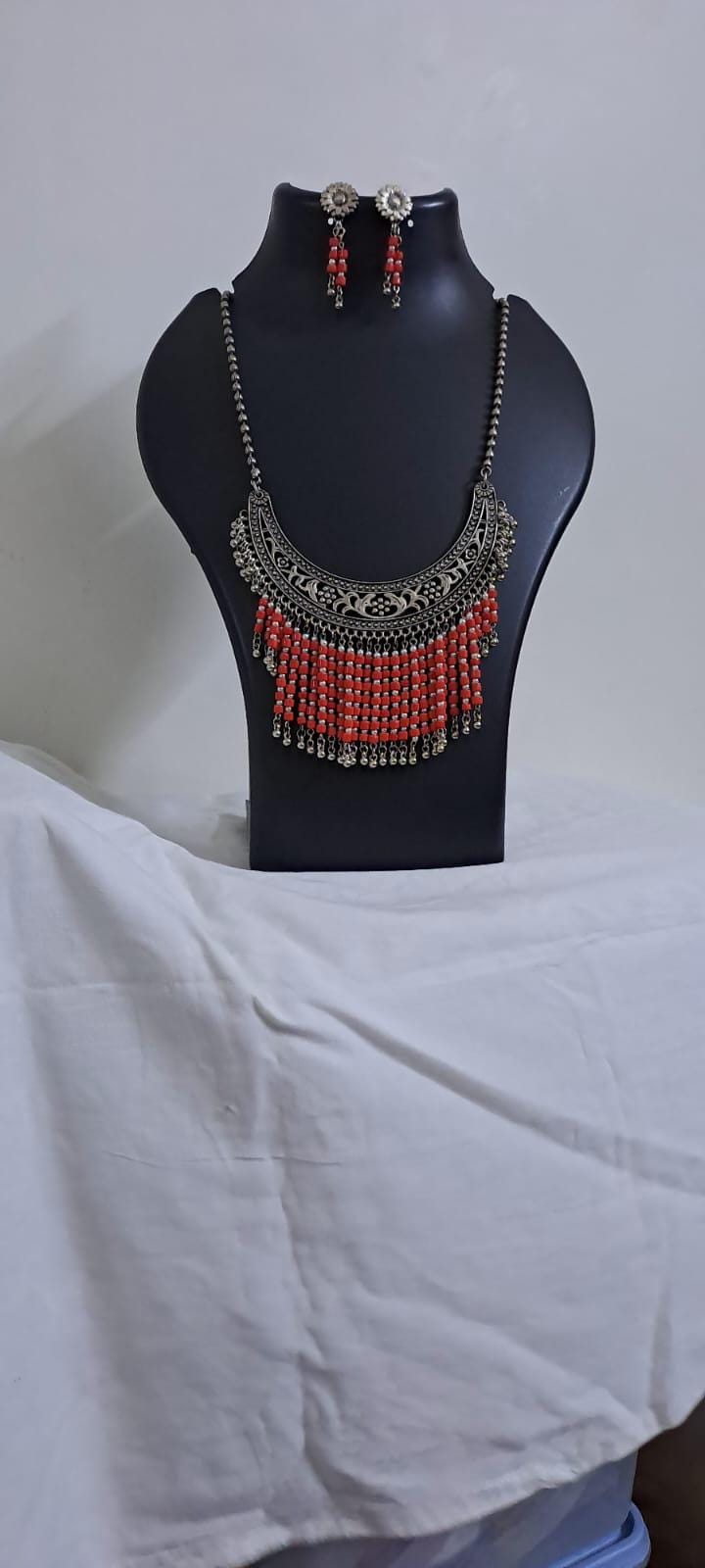 Exclusive necklace with silver oxidised big oval pendant with glass beads fringes and matching earrings.