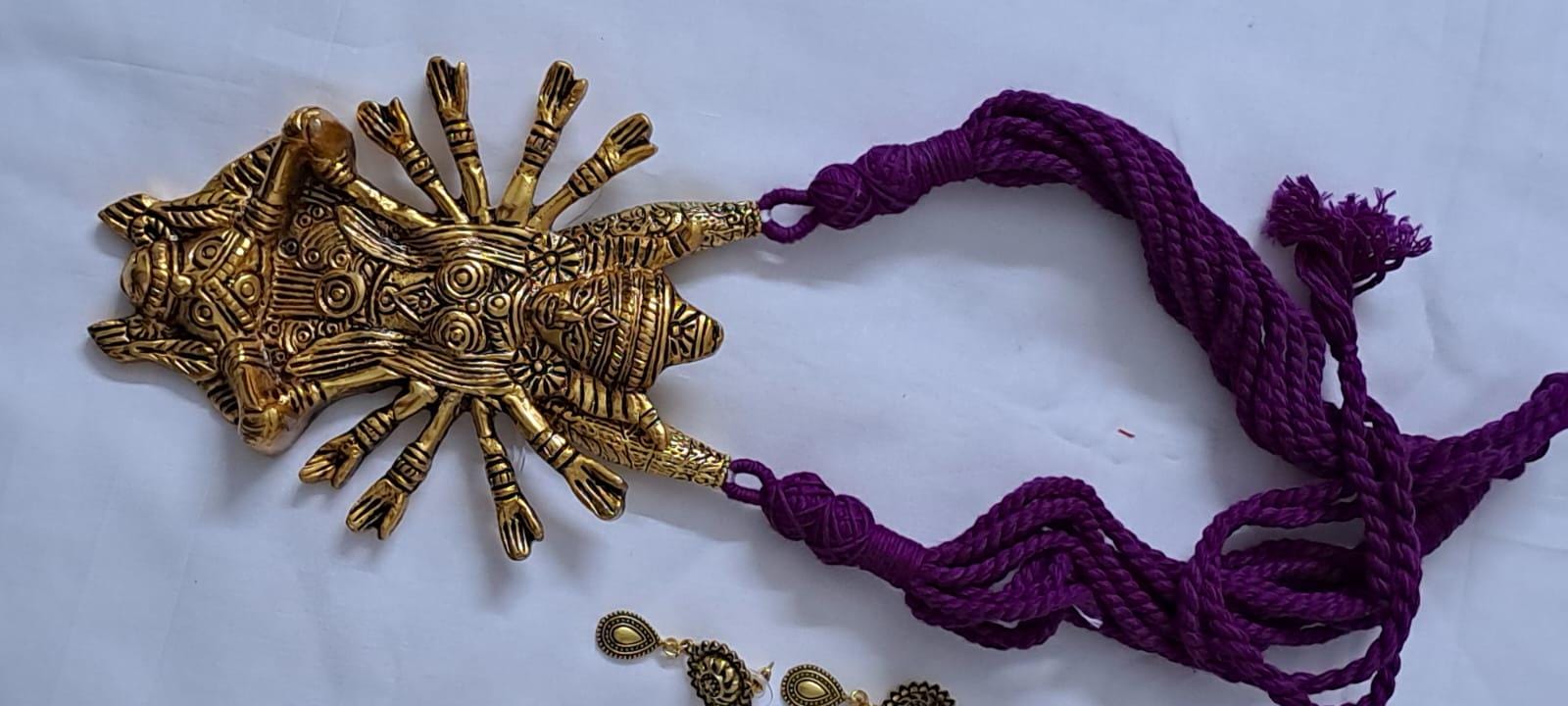 Purple thread necklace with oxidised golden durga pendant