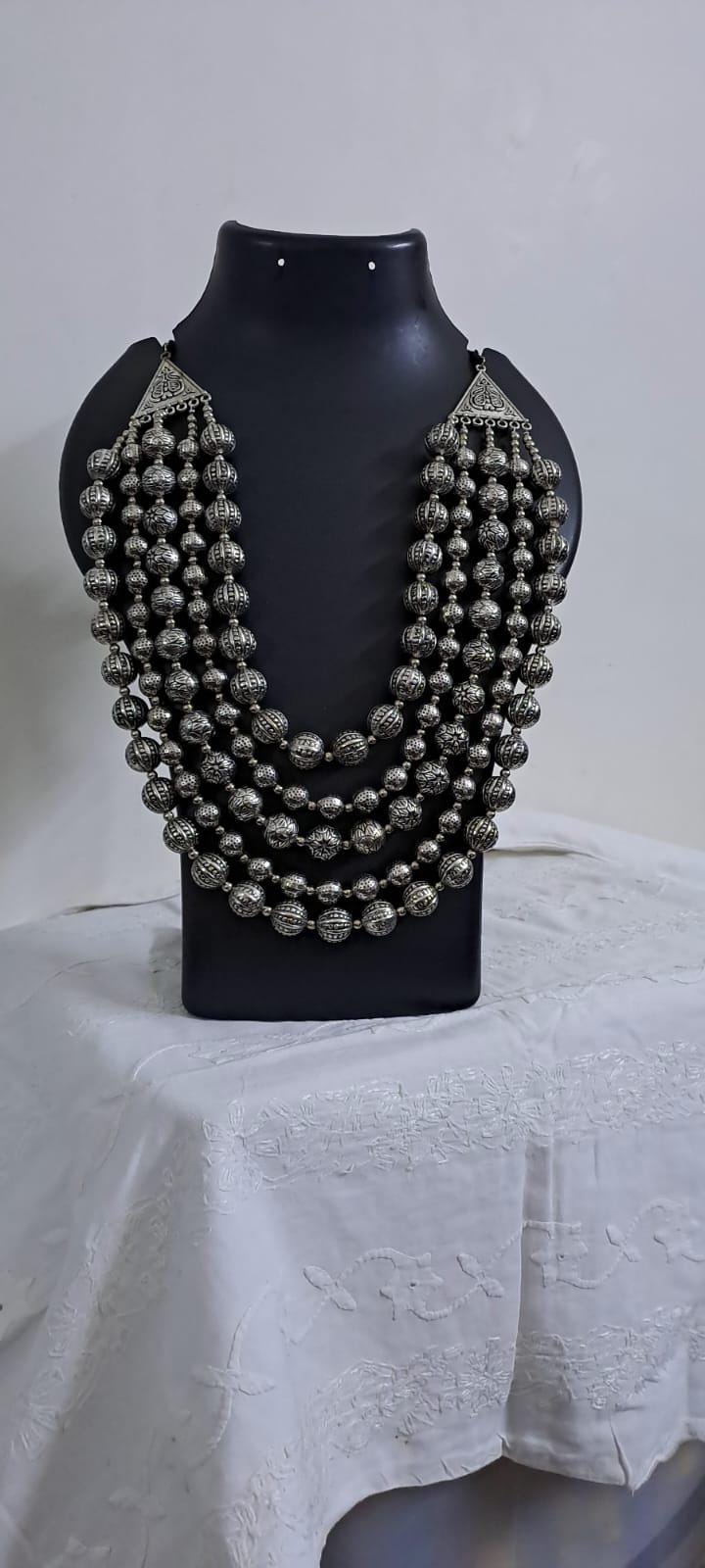 Multi-layered silver oxidised beads necklace .