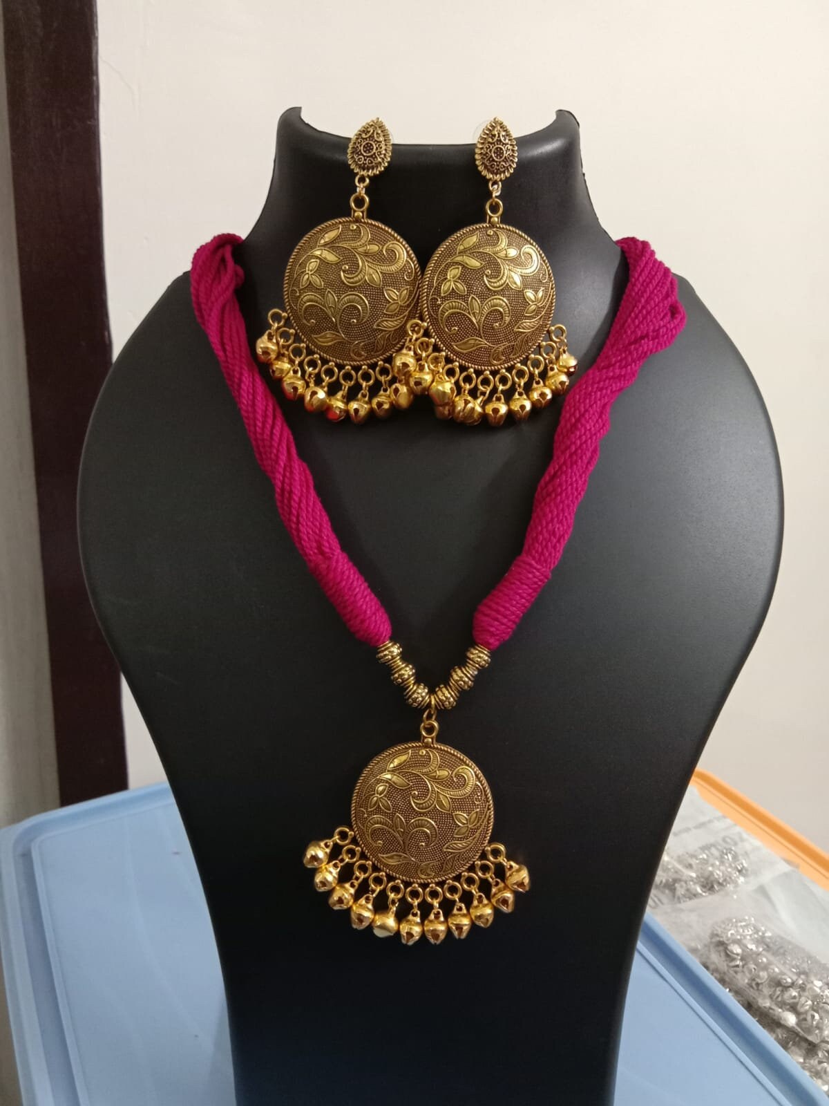 Red thread necklace with golden oxidised traditional pendant