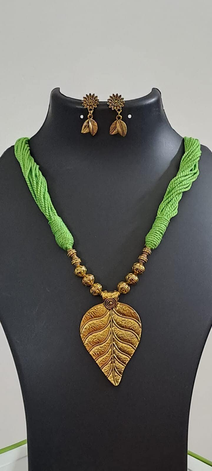 Green thread necklace with golden oxidised golden leaf traditional pendant