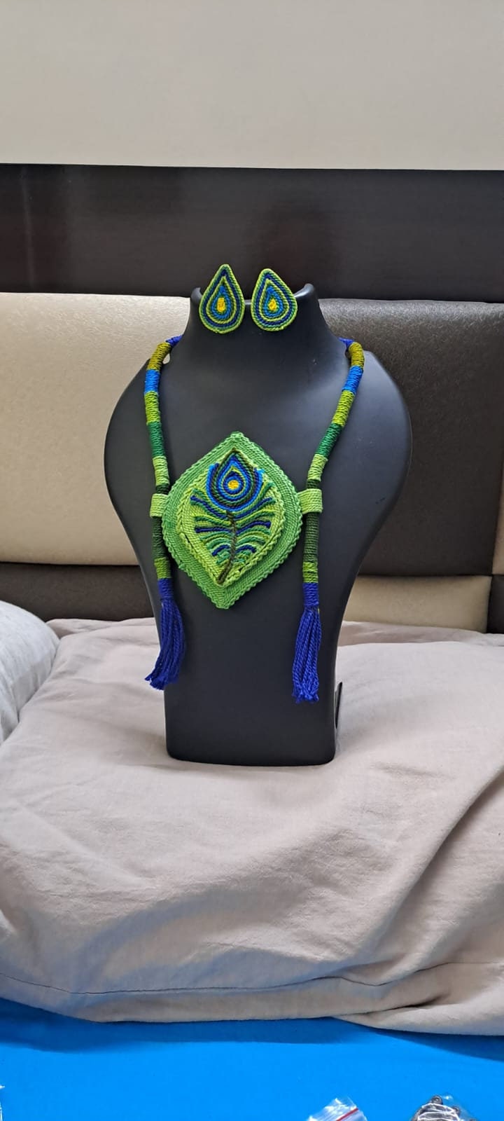 Thread necklace depicting peacock feather with shades of green. Exclusively for Janmashtami