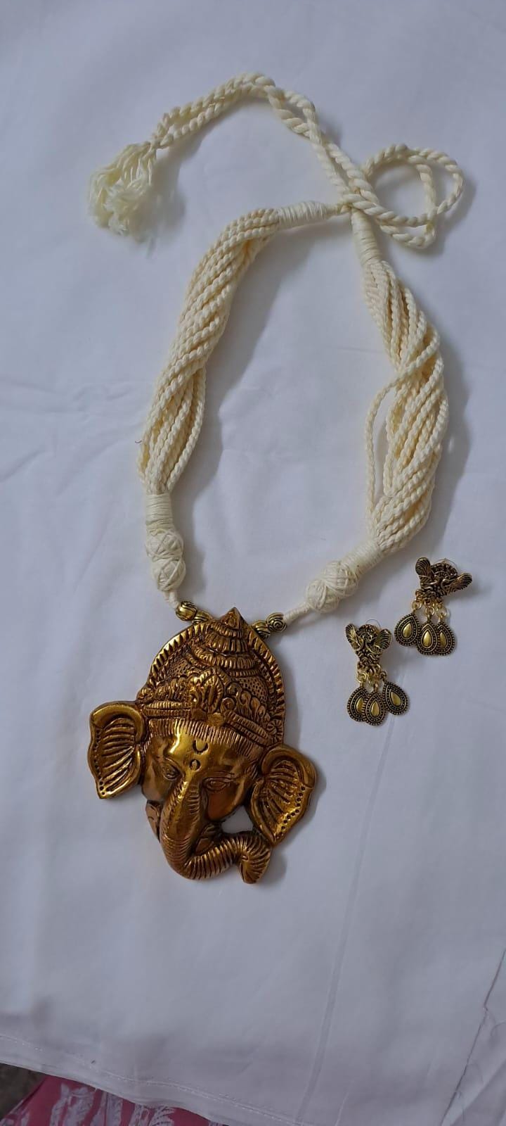 Off-white thread necklace with golden oxidised ganesha pendant