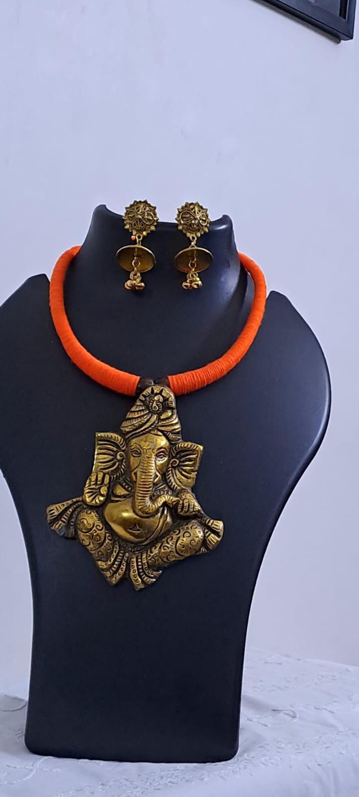 Orange thread necklace with golden oxidised ganesha pendant