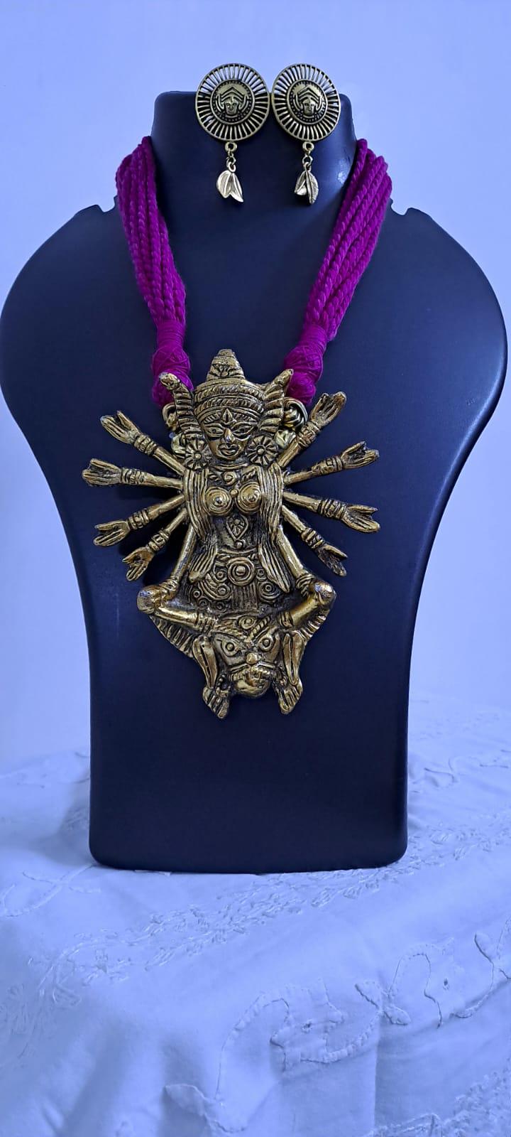 Pink thread necklace with oxidised golden durga pendant