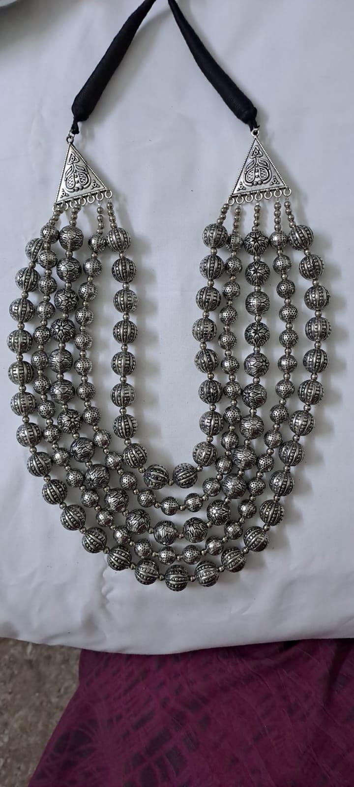 Multi-layered silver oxidised beads necklace .