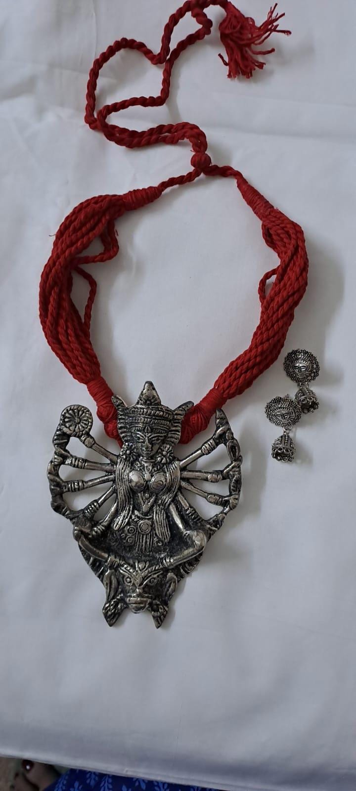 Red thread necklace with oxidised silver durga pendant