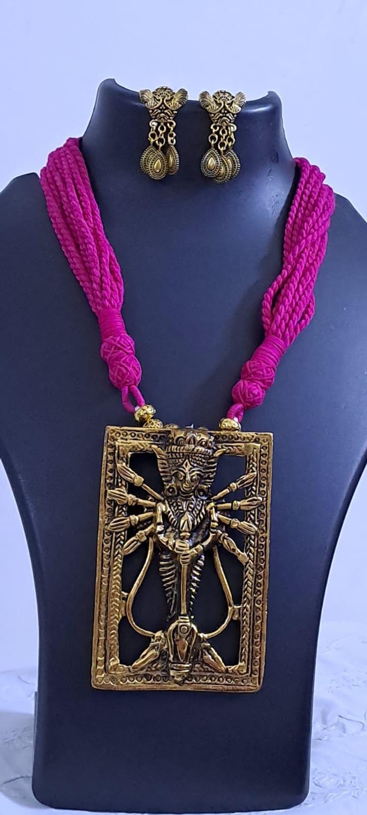 Pink thread necklace with oxidised golden durga pendant