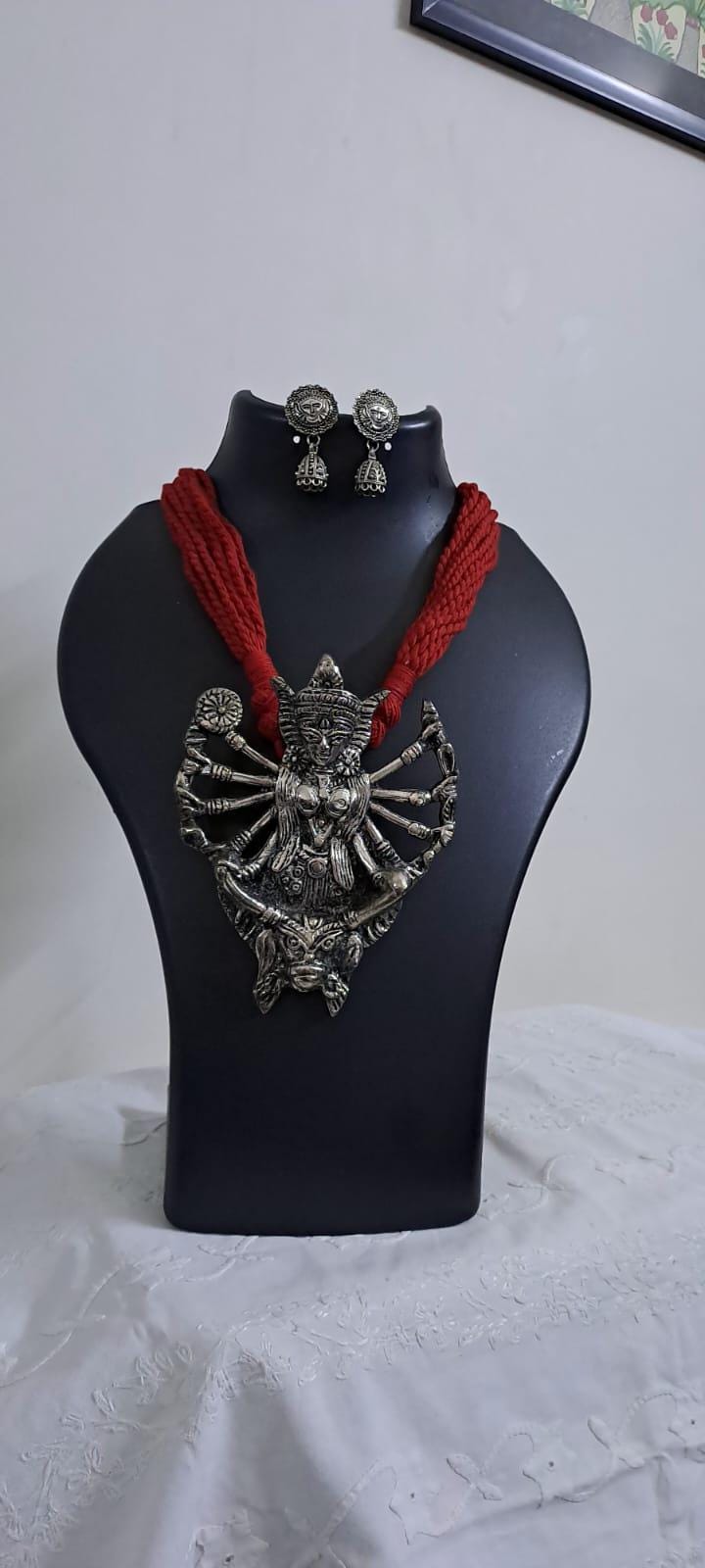 Red thread necklace with oxidised silver durga pendant