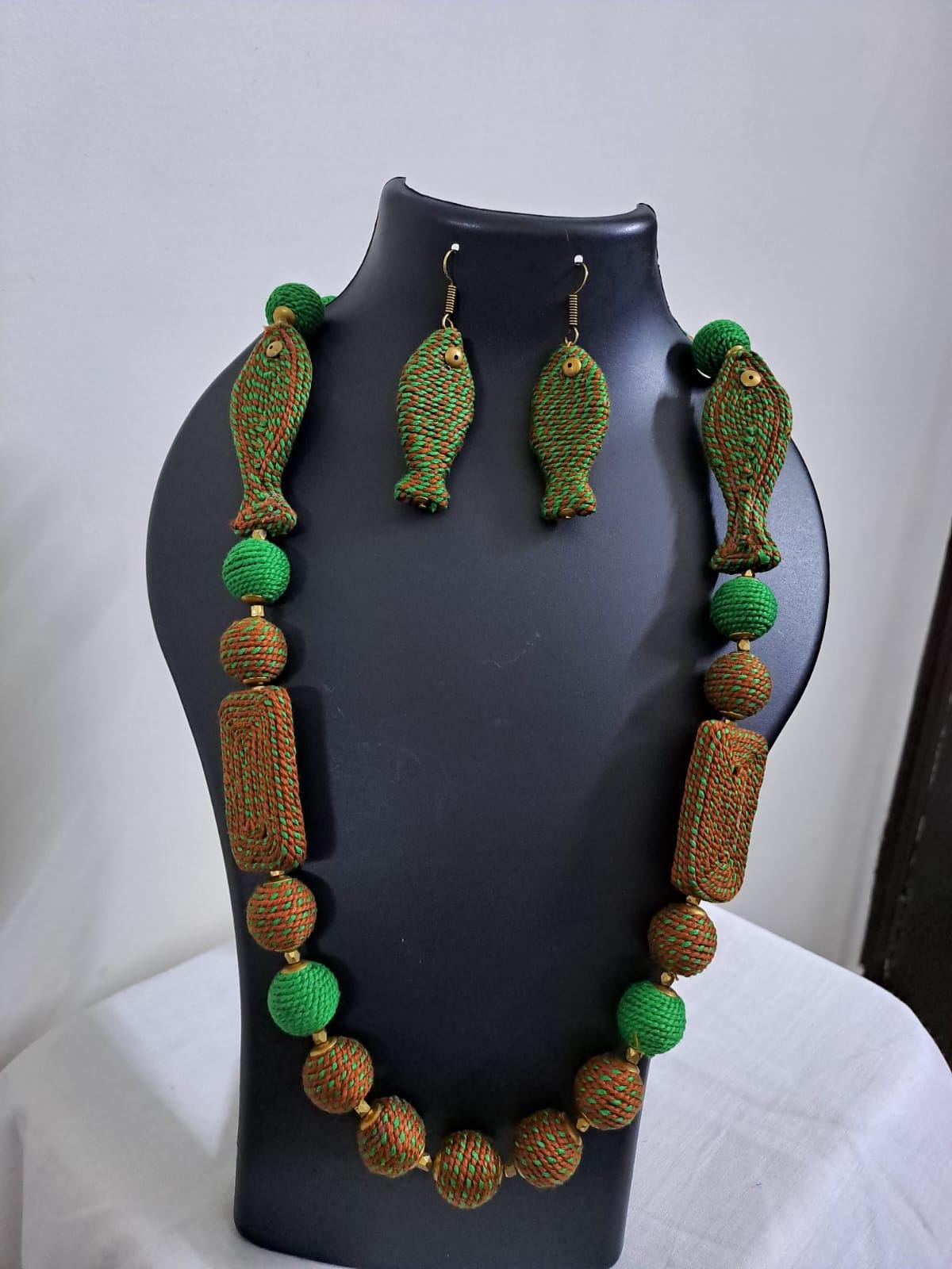 Exclusive brown n green thread necklace with fish shape thread beads and matching earrings.