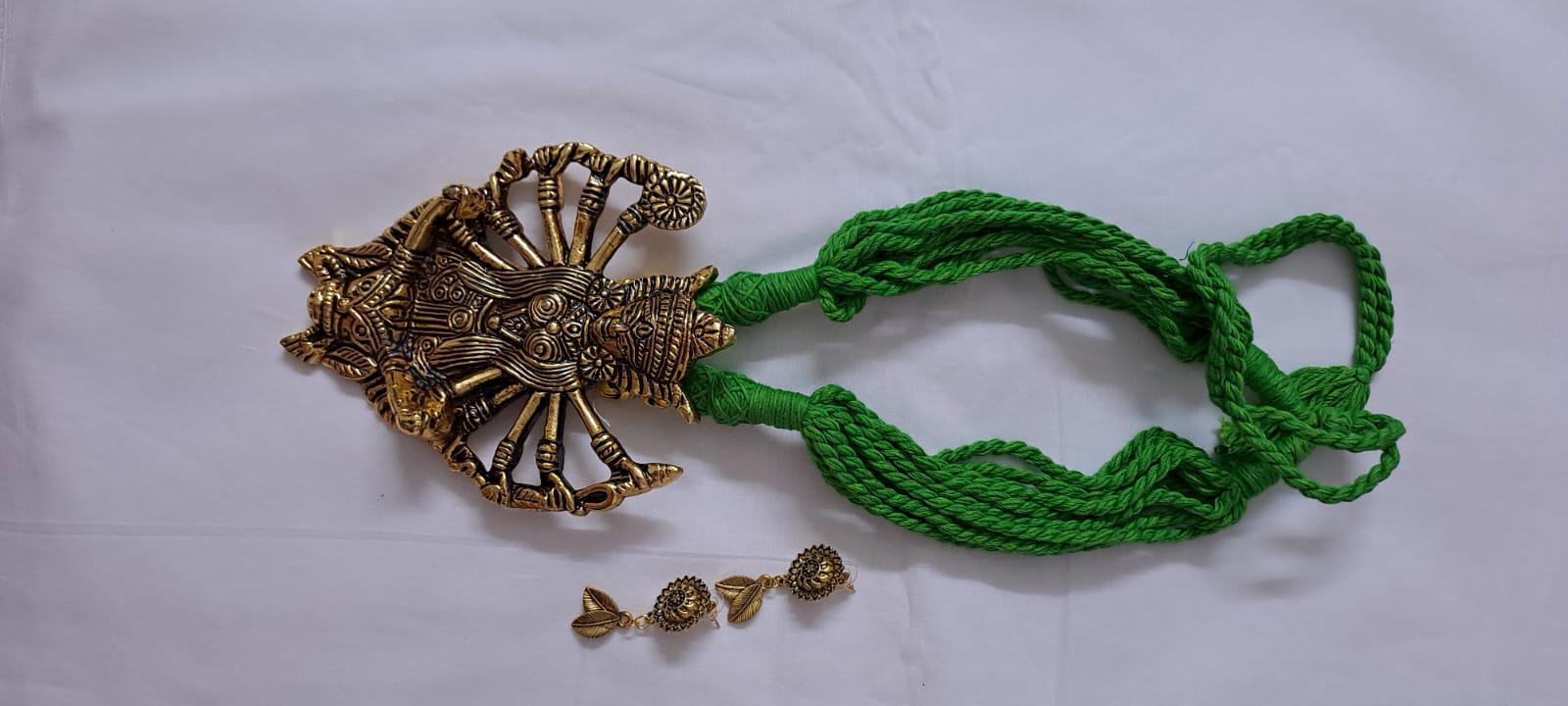 Green thread necklace with oxidised golden durga pendant