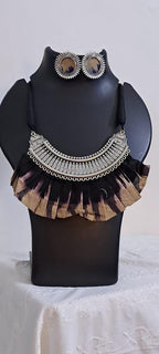 Exclusive necklace with silver oxidised big oval pendant with fabric fringes and matching earrings.