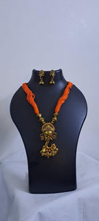 Orange thread necklace with Golden oxidised traditional pendant