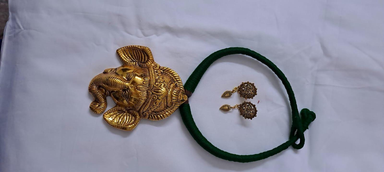 Green thread necklace with golden oxidised ganesha pendant