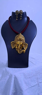 Maroon thread necklace with golden oxidised ganesha pendant