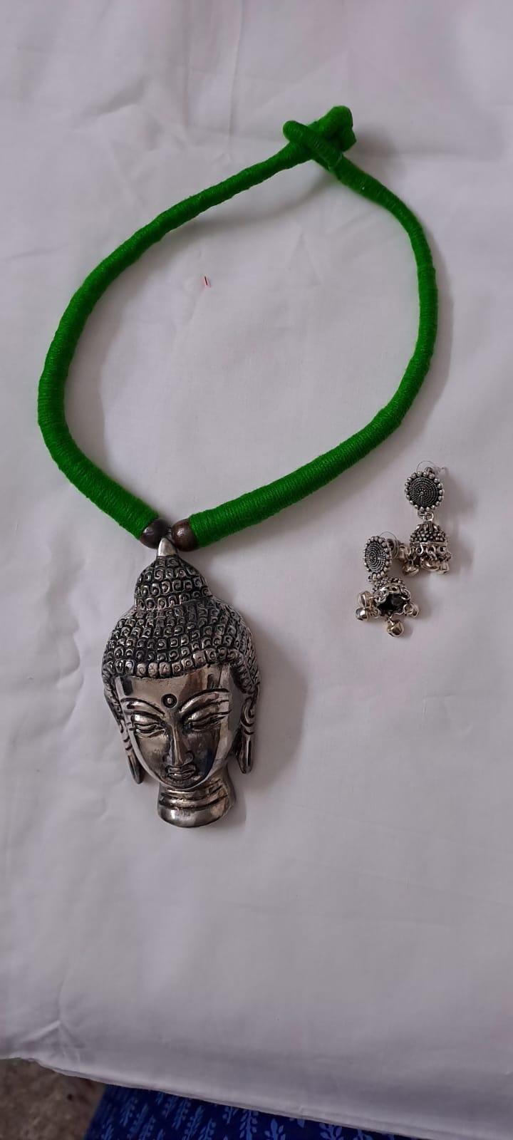 Green thread necklace with silver oxidised buddha pendant