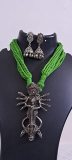 Green thread necklace with oxidised silver durga pendant
