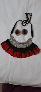 Exclusive necklace with silver oxidised big oval pendant with fabric fringes and matching earrings.