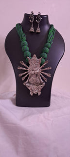 Green thread necklace with oxidised golden durga pendant