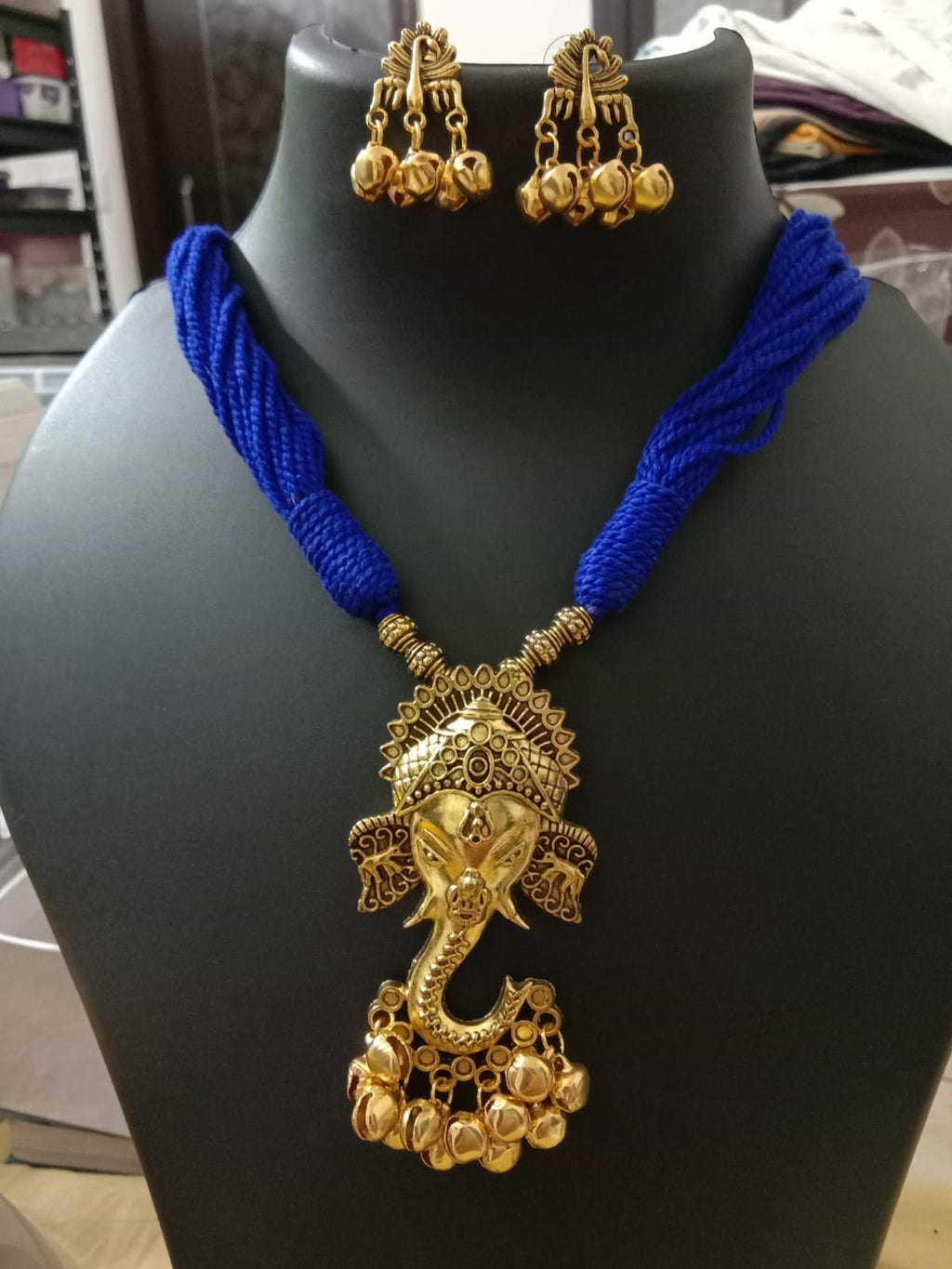 Oxidised golden ganesha traditional pendant and matching earrings.