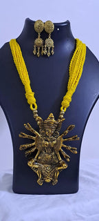 Yellow thread necklace with oxidised golden durga pendant
