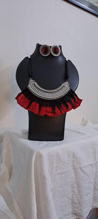 Exclusive necklace with silver oxidised big oval pendant with fabric fringes and matching earrings.