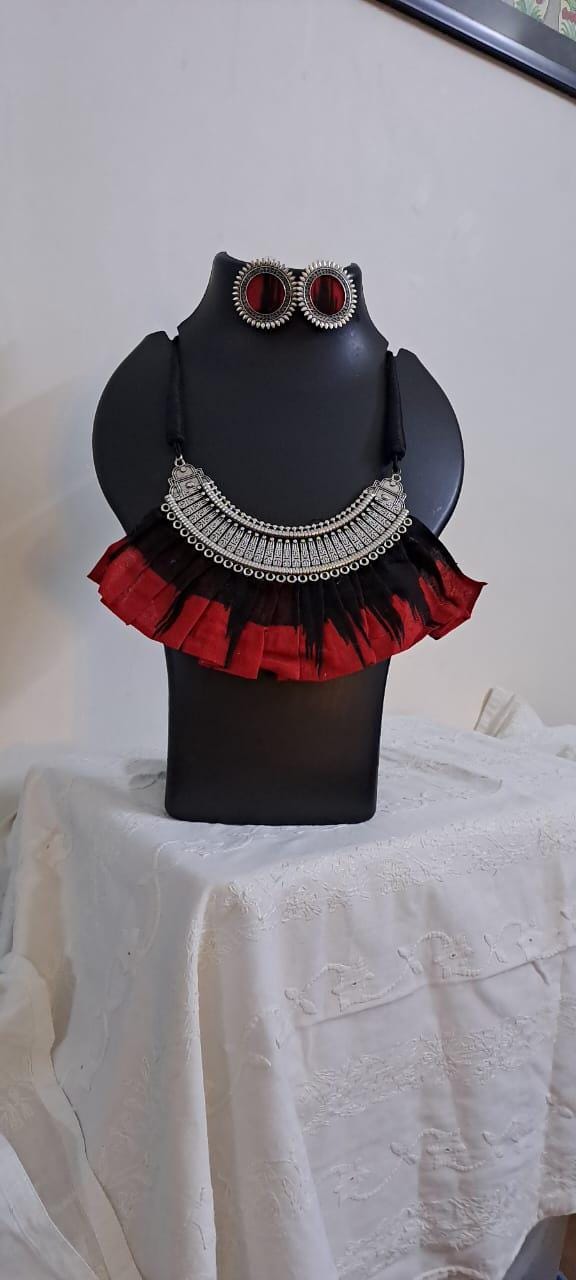 Exclusive necklace with silver oxidised big oval pendant with fabric fringes and matching earrings.