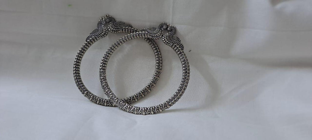 Traditional silver oxidised bangles with peacock