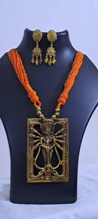 Orange thread necklace with oxidised golden durga pendant