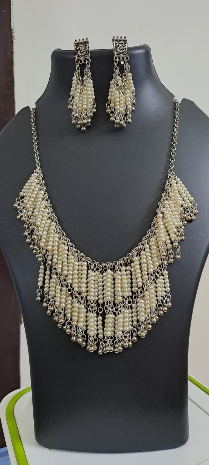 Exclusive layered off white seed beads necklace with matching hanging earrings.