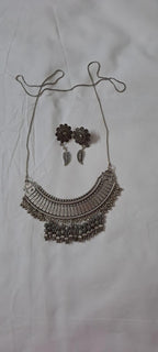 Exclusive necklace with silver oxidised big oval pendant with beads fringes and matching earrings.