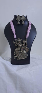 Radha Krishna silver oxidised pendant necklace in pink thread with matching earrings