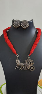Red thread necklace with silver oxidised traditional pendant