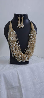 Multi layered jute necklace with pearl beads and with matching earrings.