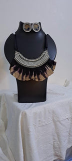 Exclusive necklace with silver oxidised big oval pendant with fabric fringes and matching earrings.