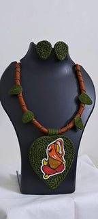 Exclusive forest green and brown thread necklace with leaf shaped  Ganesha thread pendant and matching earrings.