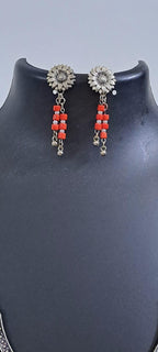 Exclusive necklace with silver oxidised big oval pendant with glass beads fringes and matching earrings.