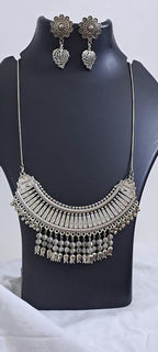 Exclusive necklace with silver oxidised big oval pendant with beads fringes and matching earrings.