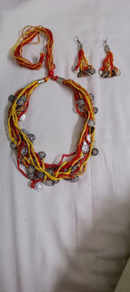 Exclusive multi-coloured and multi-layered thread necklace with silver oxidised charms