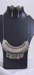 Exclusive necklace with silver oxidised big oval pendant with beads fringes and matching earrings.