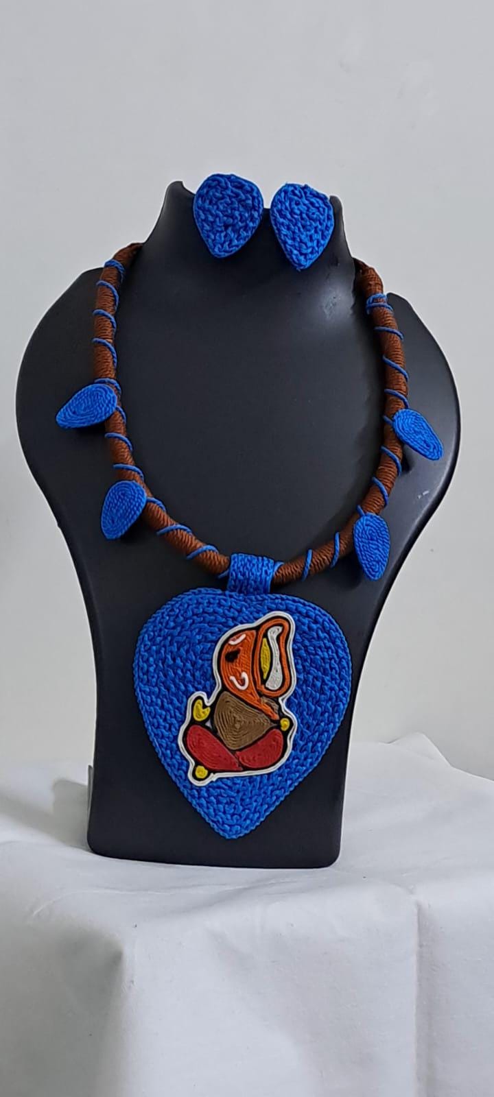 Exclusive brown and blue thread necklace with leaf shaped  Ganesha thread pendant and matching earrings.