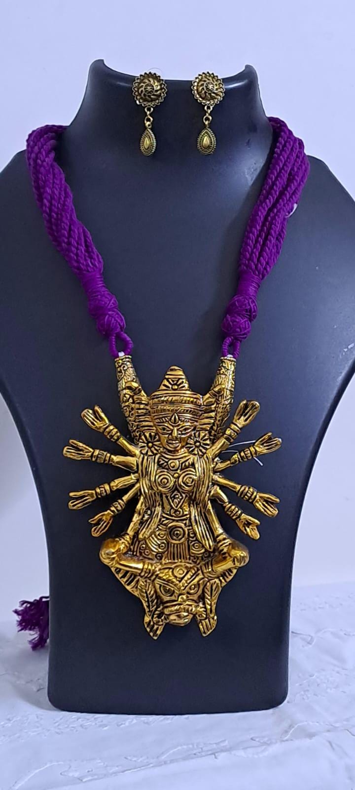 Purple thread necklace with oxidised golden durga pendant